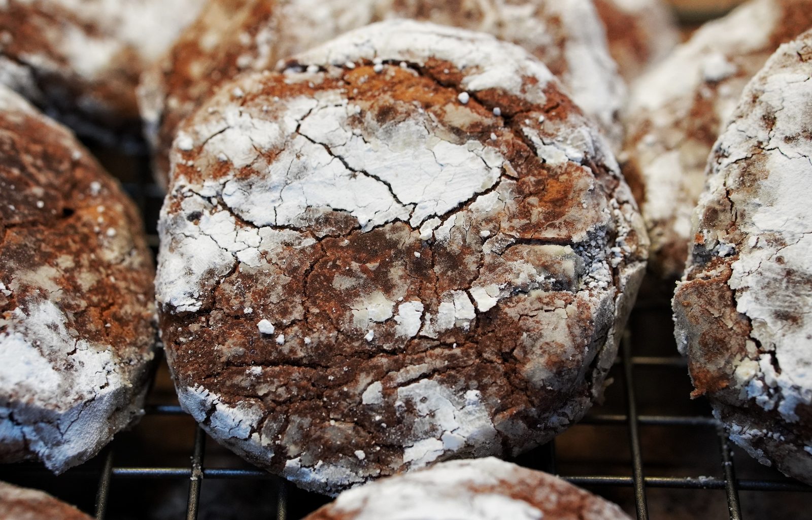 Chocolate crinkle cookies on a cooling rack
